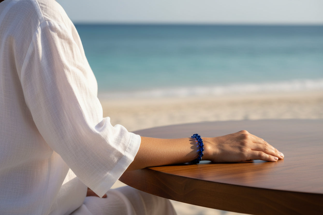 Blue beaded amber bracelet on a white background